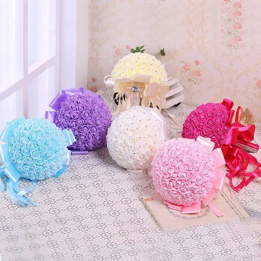 0053 A wedding bouquet of artificial white roses, a bride holding a bridesmaid bouquet of artificial flowers, and a wedding bouquet